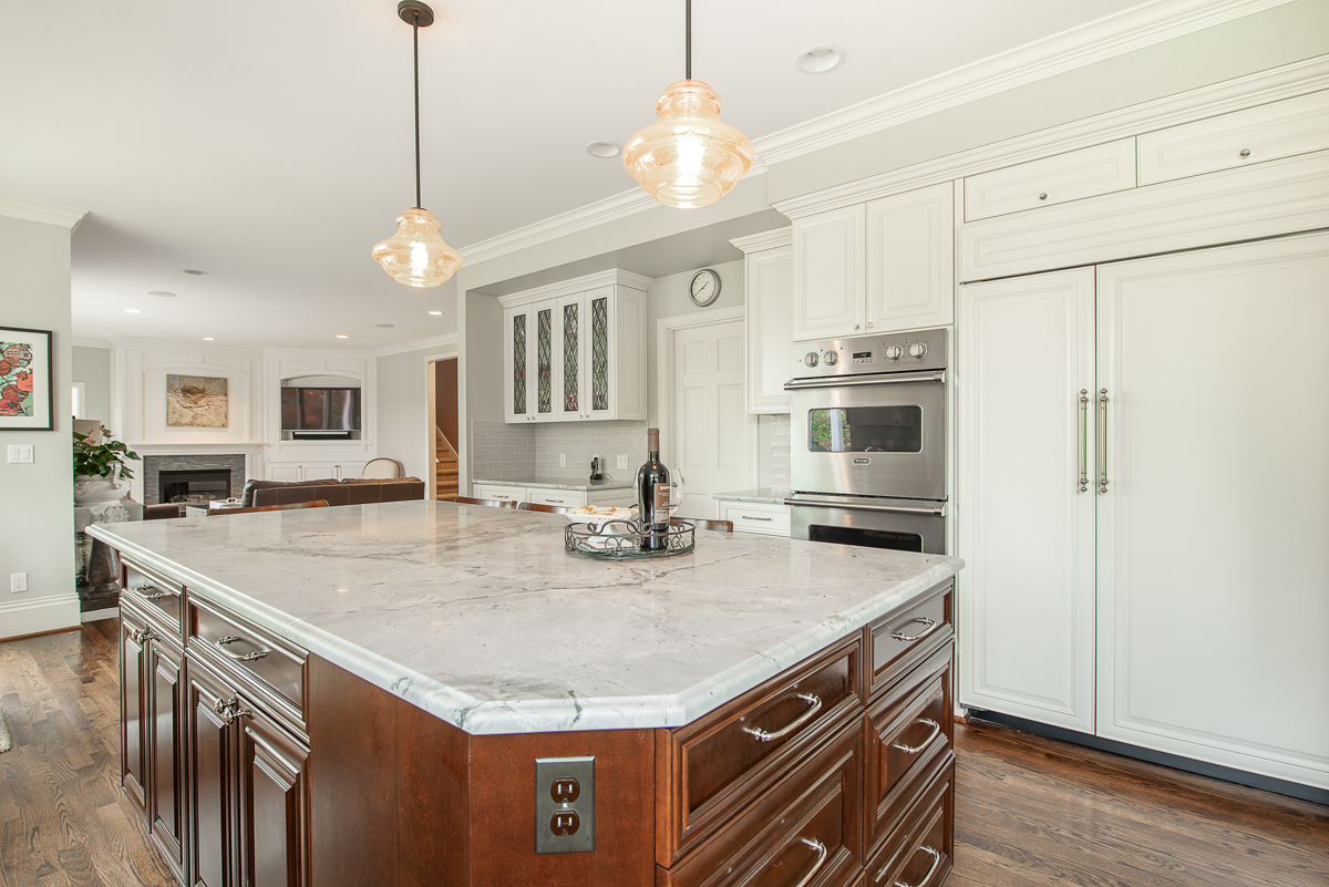 Quartzite countertops create a clean and crisp palette.  The Sub-Zero Refridgerator and the Viking ovens and warming drawer are featured on one side of the kitchen with the walk-in pantry.